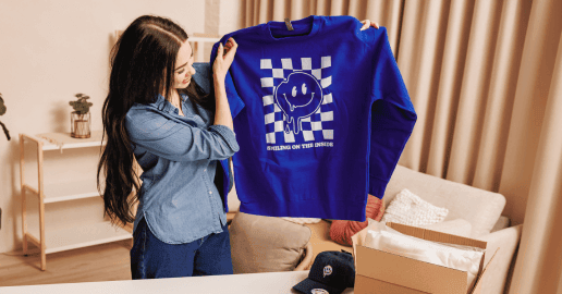 woman holding up a print on demand hoodie