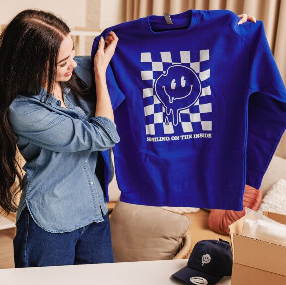 girl holding shirt