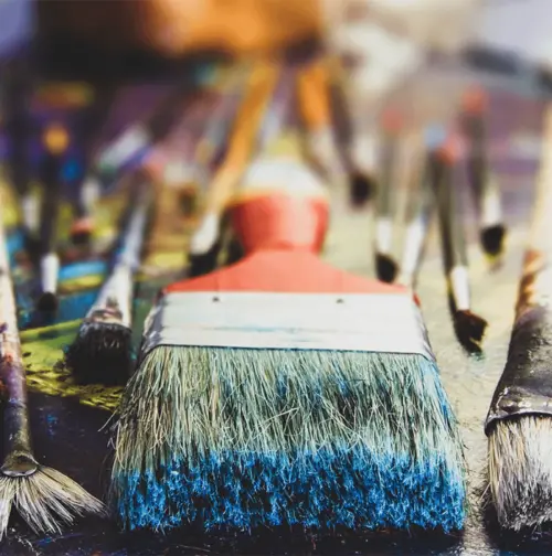 Stained paint brushes on a table