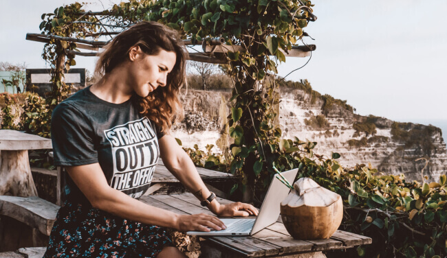 a person sitting at a desk with a laptop